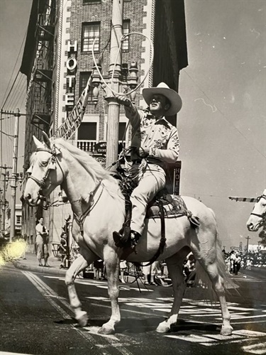 A cowboy with his horse and a lasso at the Culver Hotel
